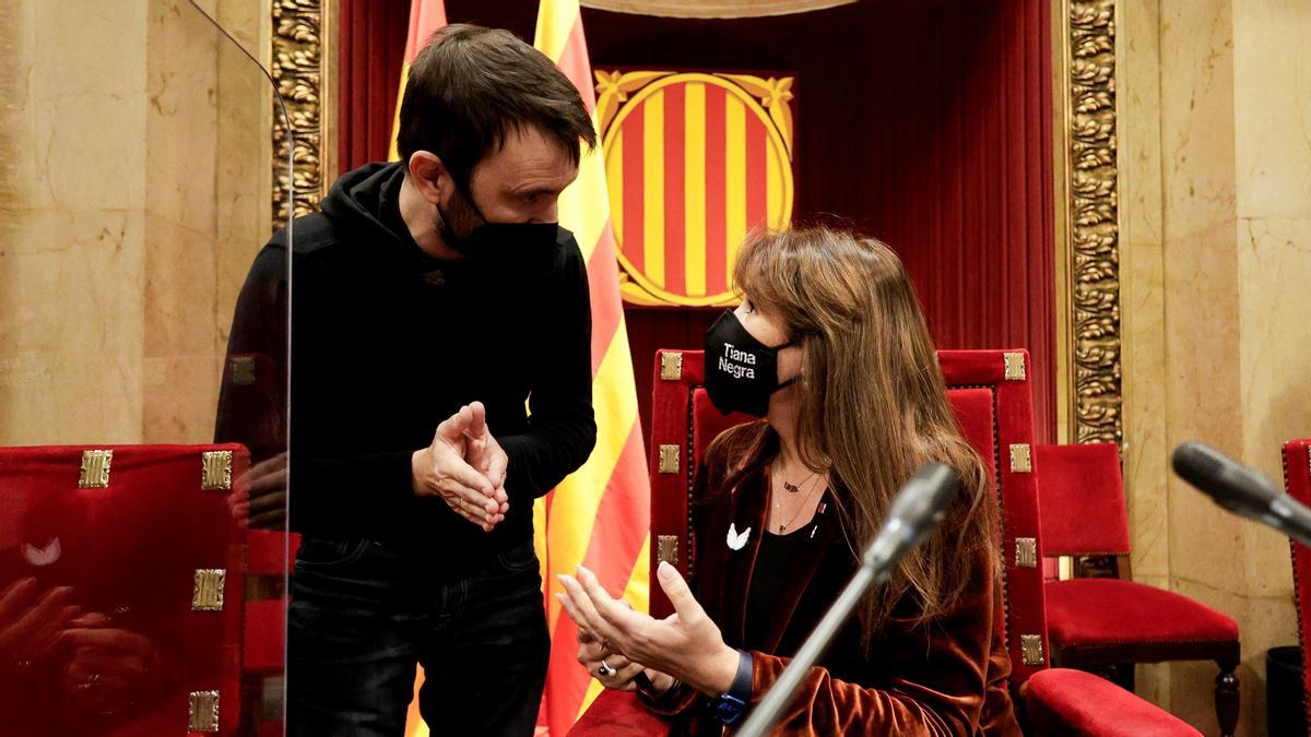 El diputado de la CUP, Pau Juvillà, conversa con la presidenta del Parlament catalán, Laura Borràs.