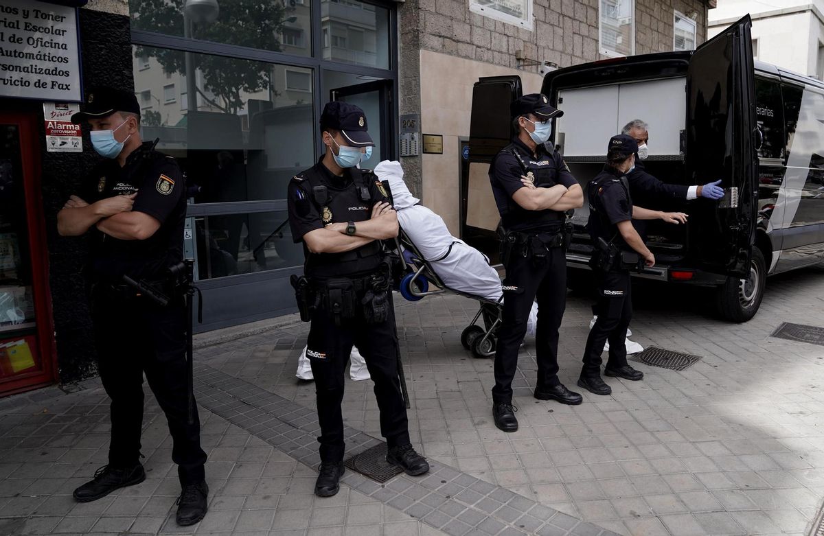 Los forenses trasladando uno de los tres cadáveres en la calle Serrano de Madrid. Los forenses trasladando uno de los tres cadáveres en la calle Serrano de Madrid.