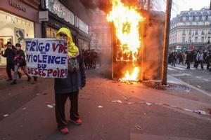 Un manifestante muestra un cartel con el texto ’nevera vacía = violencia de los desesperados’ durante una manifestación contra la reforma de las pensiones en París.