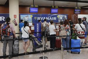 Several passengers stand in a queue in front of a Ryanair check-in desk at Terminal 2 of Barcelona-El Prat airport, Spain, 15 August 2022. Ryanair’s cabin crew begins a four-day strike in Spain on 15 August causing six flights were canceled and 78 other were delayed so far.EFE/ Quique Garcia