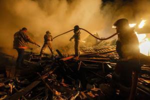 Agentes de bomberos trabajan en la extinción de un incendio provocado por un misil en el Donbás.