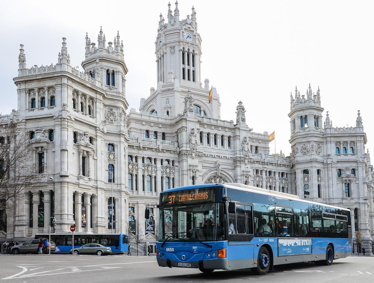 Autobús urbano de Madrid a su paso por delante de la sede principal del Ayuntamiento, el Palacio de las Telecomunicaciones.