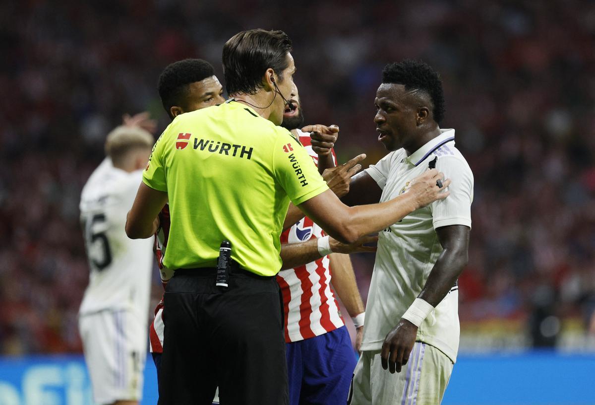 Vinicius Jr. discute con el árbitro en el reciente Atlético-Real Madrid.